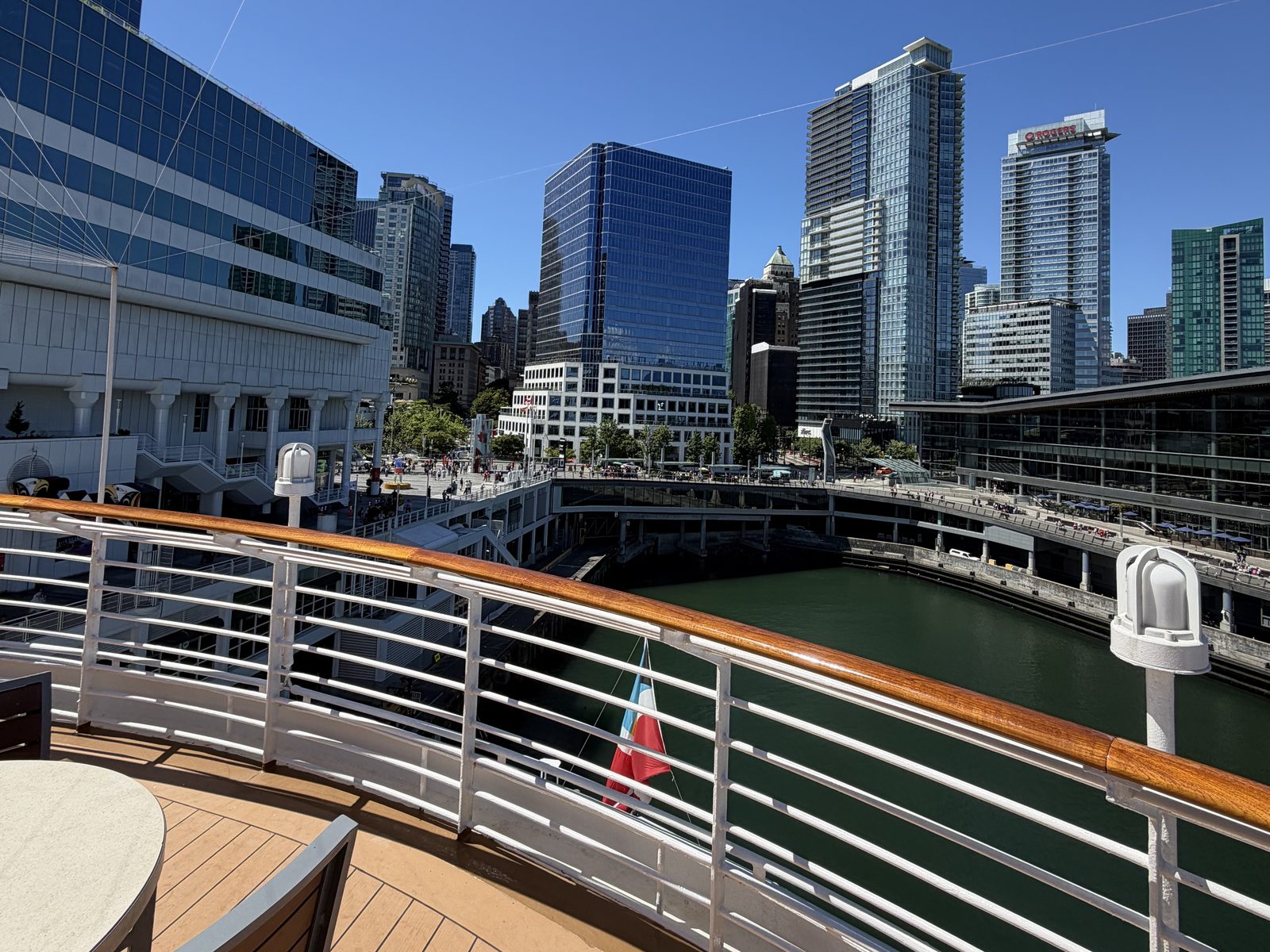 Vancouver's towers from the ship's rail, a Canadian flag flying, on sailaway