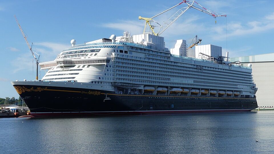 The Disney Adventure fitting out at Wismar, cranes above her